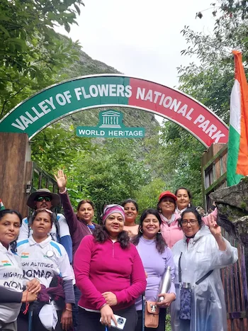 Group of happy trekkers posing at the entrance gate of Valley of Flowers National Park.